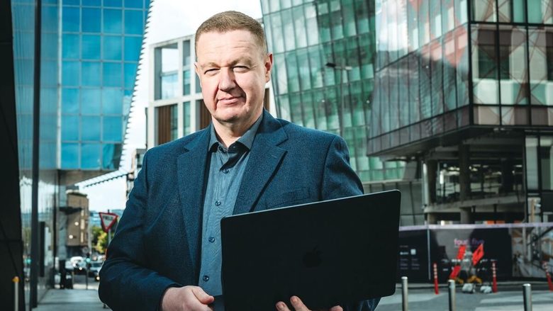 Kyran O'Mahoney, Nexus Inclusion's Founder, holding a laptop