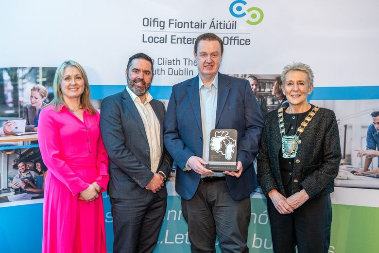 Nexus Inclusion CEO Kyran O'Mahoney holding an award, accompanied by the South County Dublin Mayor and staff from the Local Enterprise Office